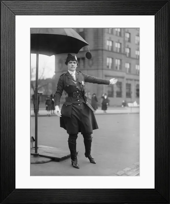 Framed Print : Policewoman directing traffic in Washington, D.C. in 1918. Her progressive uniform combines knee high boots, below knee pants, and a knee length jacket