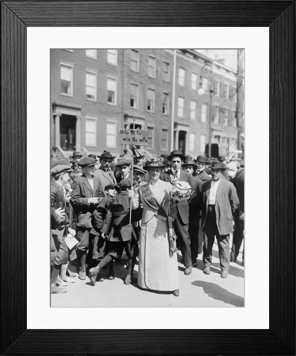 Framed Print : Women identified as Mrs. Suffern, is surrounded by a crowd of men and boys, while she holds a home-made banner in women suffragist parade Help us to win the vote. 1914 Framed Print : Women identified as Mrs. Suffern, is surrounded by a crowd of men and boys, while she holds a home-made banner in women suffragist parade Help us to win the vote. 1914