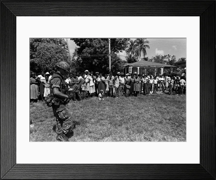 Framed Print : Marine guards civilians after his battalion landed on Grenada during the U.S. invasion. Oct 25-Nov 3 1983. (BSLOC_2011_3_25)