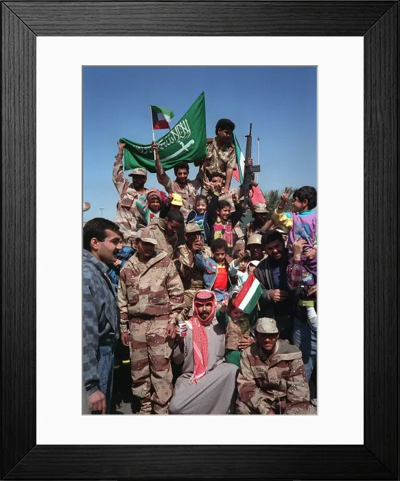 Framed Print : Civilians and coalition military forces wave Kuwaiti and Saudi Arabian flags to celebrate the retreat of Iraqi forces from Kuwait as a result of Operation Desert Storm