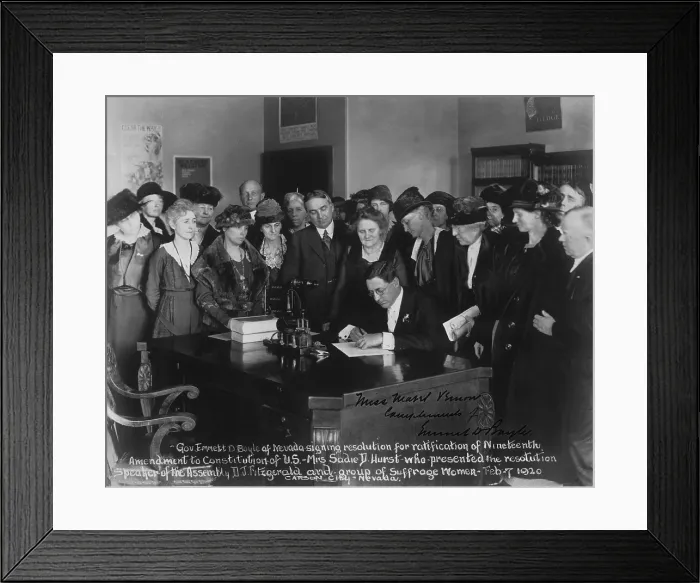 Framed Print : Governor Emmett D. Boyle of Nevada signing resolution for ratification of Nineteenth Amendment to Constitution of U.S. as a group of suffragists watch