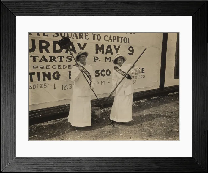 Framed Print : Two members of the Congressional Union for Woman Suffrage holding brushes in front of a large billboard advertisement for the procession to Congress on May 9th Framed Print : Two members of the Congressional Union for Woman Suffrage holding brushes in front of a large billboard advertisement for the procession to Congress on May 9th