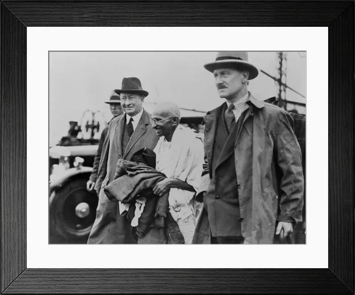 Framed Print : Mahatma Gandhi escorted to his automobile by two detectives. He arrived at Folkstone, U.K