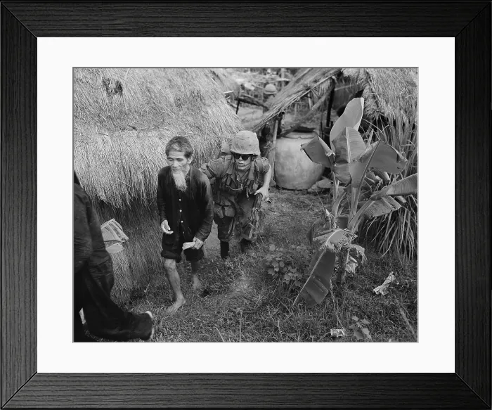 Framed Print : Suspected Viet Cong detainee. US Marine captures an elderly Viet Cong suspect during a search and clear operation 15 miles west of Da Nang Air Base. Aug. 3, 1965