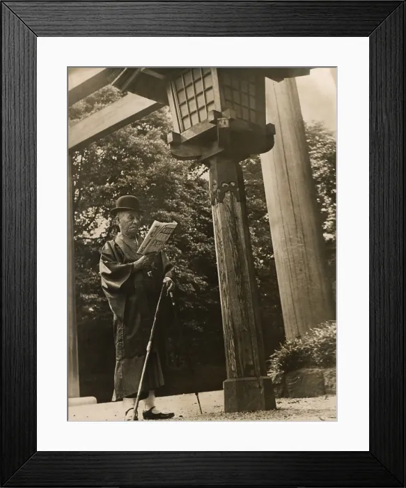 Framed Print : Mikimoto Kokichi, founder of the luxury pearl jewelry company, ca. 1930s. Mikimoto is dressed in a traditional Japanese kimono, reading his morning paper. (BSLOC_2013_9_87)