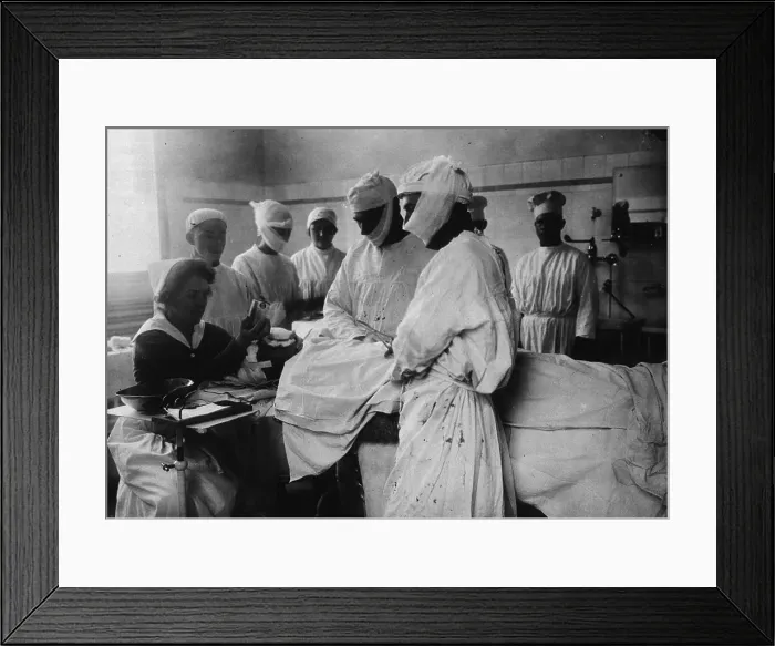 Framed Print : Masked surgeons perform an operation while a nurse administers ether to anesthetize patient. Ca. 1920 Framed Print : Masked surgeons perform an operation while a nurse administers ether to anesthetize patient. Ca. 1920