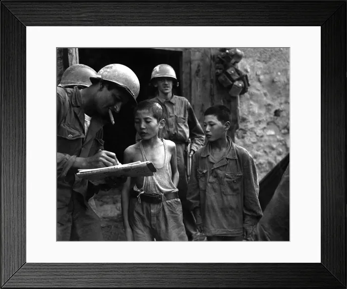 Framed Print : Two young North Korean soldiers taken prisoner in the Sindang-dong area (near Seoul). They are interrogated by a U.S. soldier shortly after their capture. Sept. 18, 1950