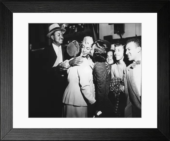 Framed Print : Army First Lt. Alvin Anderson embracing his mother and sister as his family looks on. He spent 33 months as a POW during the Korean War. Sept. 14, 1953. Fort Mason, California