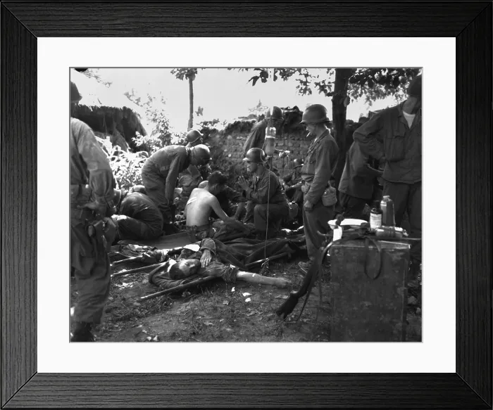 Framed Print : U.S. soldiers receive medical treatment at a first aid station near South Korean battle front. July 25, 1950