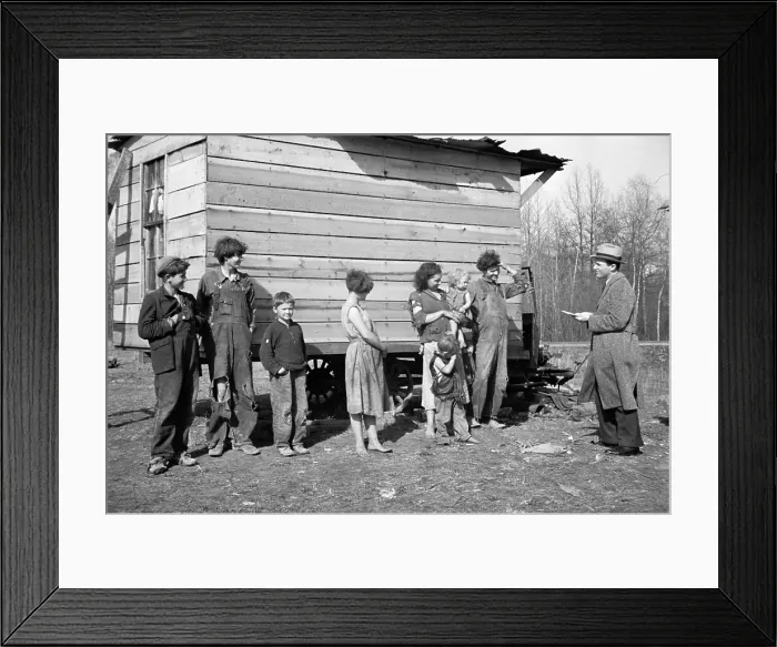 Framed Print : New Deal official investigating case of a family of nine living in field off U.S. Route 70. The shack built on an old truck chassis is their dwelling near Tennessee River