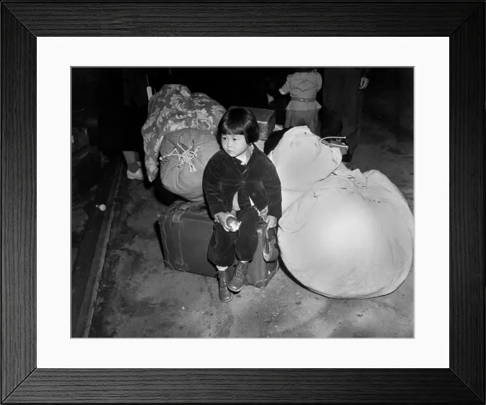 Framed Print : Japanese-American little girl waits with the family baggage, April 1942. With her family, she will be sent to a remote internment camp for the duration of World War 2 Framed Print : Japanese-American little girl waits with the family baggage, April 1942. With her family, she will be sent to a remote internment camp for the duration of World War 2