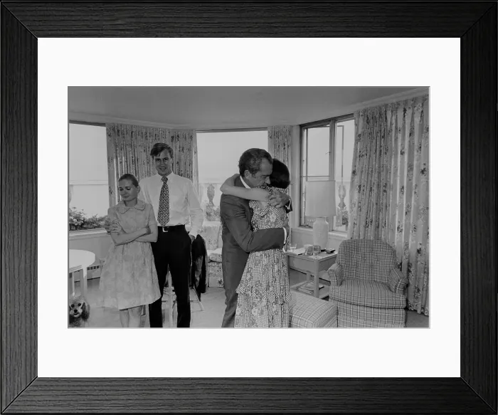Framed Print : Nixon hugging his daughter Julie shortly after his decision to resign from the Presidency. In background are Edward and Tricia Nixon Cox. Aug. 8 1974