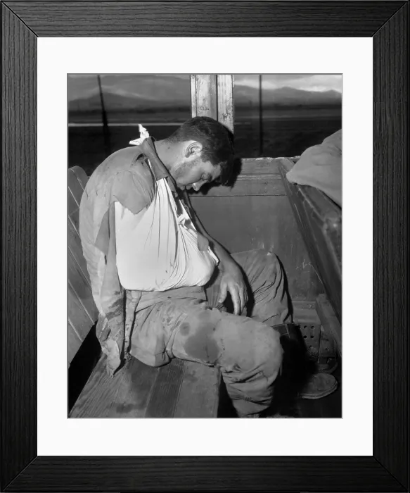 Framed Print : U.S. soldier wounded by enemy mortar fire on front lines during in South Korea. He is on a hospital train bound for Pusan on July 29, 1950. Korean War, 1950-53. (BSLOC_2014_11_19)