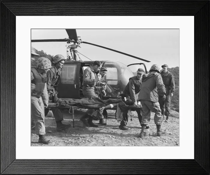 Framed Print : A seriously wounded U.S. Marine is rushed to helicopter by the Corpsmen. He will receive emergency treatment at an aid station located in the Teng-Mak area in Korea. Feb