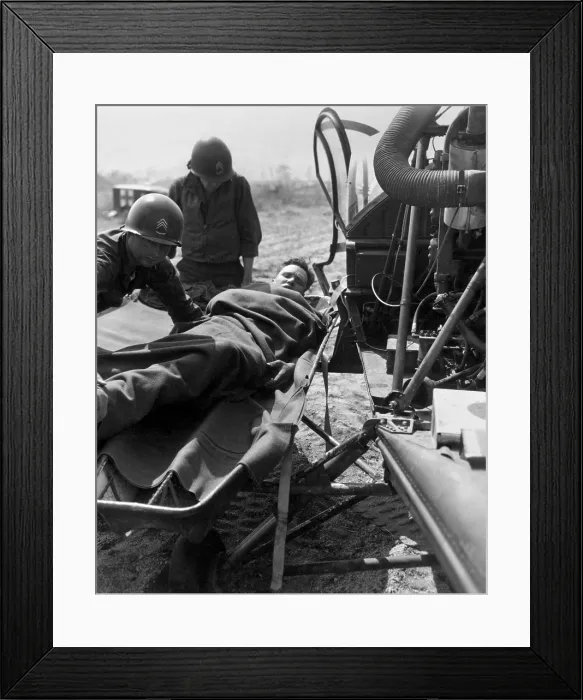 Framed Print : Wounded U.S. soldier lifted onto a helicopter for evacuation to a base hospital