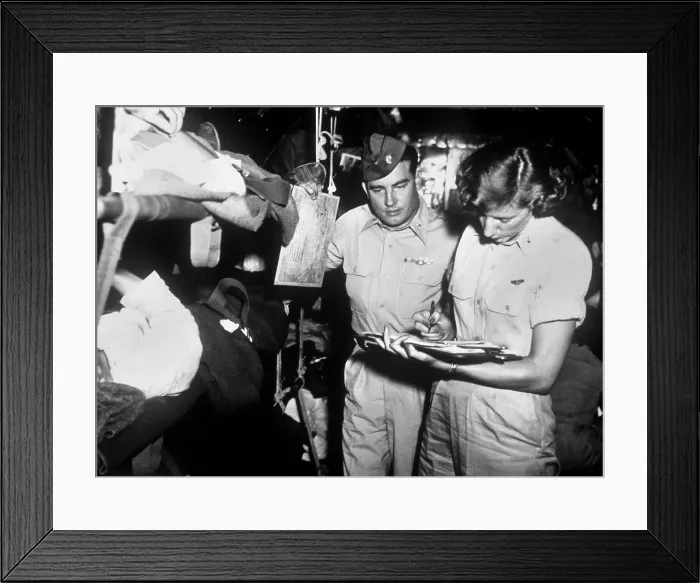 Framed Print : U.S. flight nurse checks patient records with C-54 aircraft commander Maj. George Cichy, October 1952. Korean War, 1950-53. (BSLOC_2014_11_203) Framed Print : U.S. flight nurse checks patient records with C-54 aircraft commander Maj. George Cichy, October 1952. Korean War, 1950-53. (BSLOC_2014_11_203)