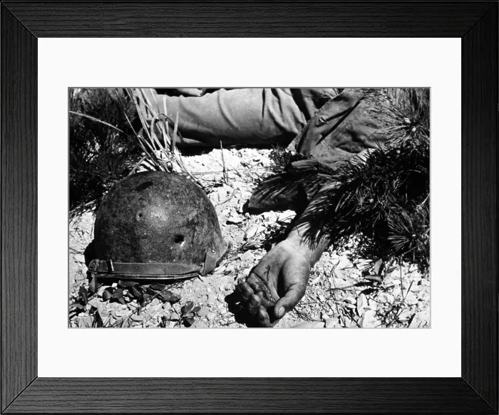 Framed Print : U.S. soldier's bullet-pierced helmet lying next to his body in a South Korean battlefield. He was killed in an advance on Maeson Dong during Korean War. Sept. 2, 1950