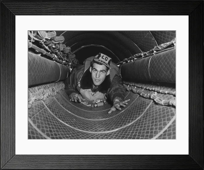 Framed Print : B-29 gunner in the 35-foot tunnel connecting the forward and rear pressurized compartments