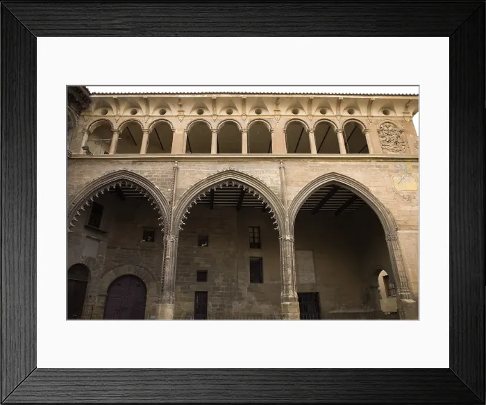 Framed Print : SPAIN. Alcaniz. Plaza de Espana (Spain's square). Guildhall built in 15th c. next to the City Hall. View of the ogival archs. Flamboyant gothic. Architecture