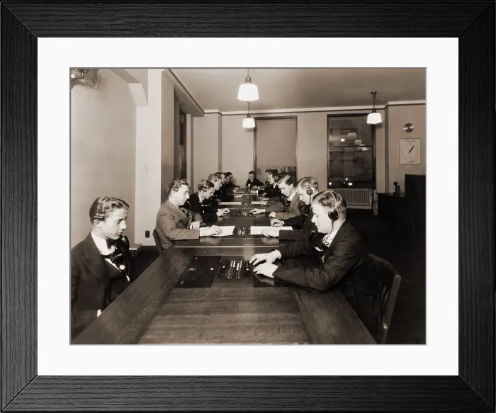 Framed Print : High technology in 1928 was the NY Stock Exchange's new quotation system. Photo shows men with headphones and mouthpieces working in the new quotation room
