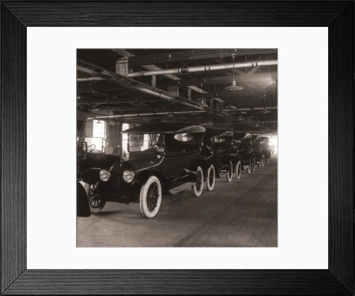 Framed Print : Row of Cadillac touring cars come off the assembly line in 1917. Cadillac was purchased by General Motors in 1909, and became its luxury line