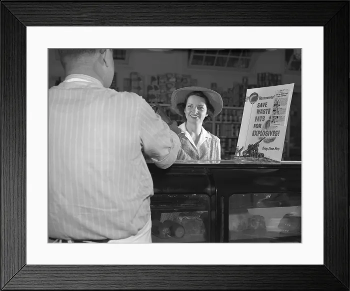 Framed Print : Women at grocery store meat counter. A sign on a grocery store counter reads Housewives-Save Waste Fats for Explosives-Bring Them Here Framed Print : Women at grocery store meat counter. A sign on a grocery store counter reads Housewives-Save Waste Fats for Explosives-Bring Them Here