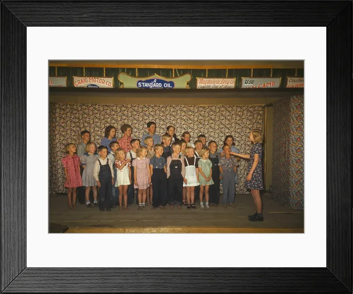 Framed Print : School children some barefoot singing on a stage Pie Town New Mexico. The stage curtain posts advertisements from local businesses Craig Motor Co