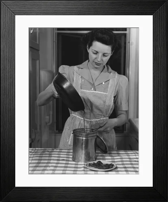 Framed Print : Housewife pouring waste fats that will be processed into ammunition for America's World War 2 military