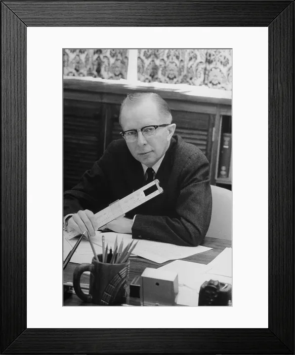 Framed Print : Economist Paul MacCraken with a slide rule. He was chairman of the President's Council of Economic Advisors from 1969 to 1971 under President Richard Nixon