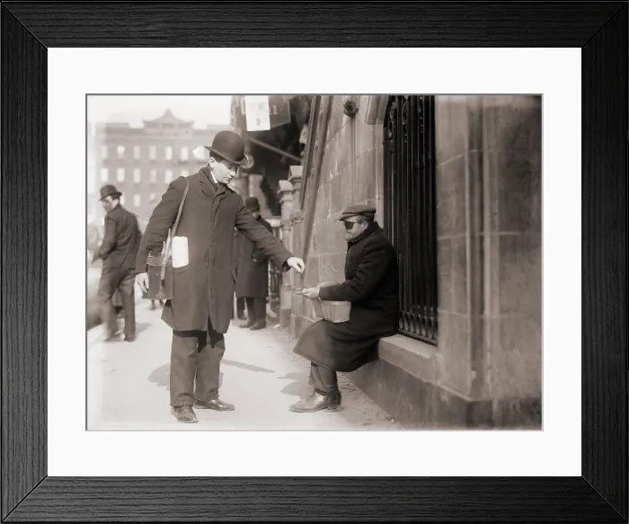 Framed Print : Disfigured beggar receiving change on a street in New York City, 1910 Framed Print : Disfigured beggar receiving change on a street in New York City, 1910