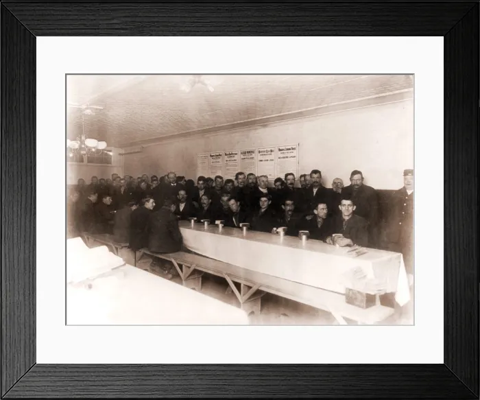 Framed Print : Men dining at New York's Municipal Lodging House in 1908. The rules of the house are posted in several languages