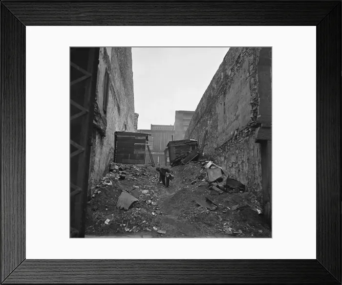 Framed Print : A homeless African American man searches through garbage in a squatter neighborhood along the riverfront in St. Louis, Missouri. 1935 photo by Arthur Rothstein