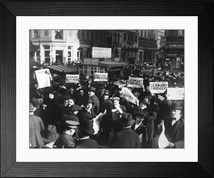 Framed Print : Headlines can be wrong. A crowd at Times Square holding up headlines reading Germany Surrenders, on November 7, 1918. Four days later, on Nov. 11