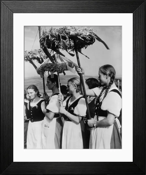 Framed Print : German women wearing traditional folk costumes during the 1935 Erntedankfest. Peasant women hold beribboned wreaths with during the Nazi celebration. (BSLOC_2013_11_22)