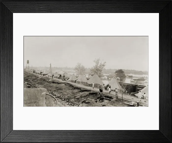 Framed Print : Refugees at a tent city on the levee, with partially submerged houses of Arkansas City in background, during the 1927 Flood Framed Print : Refugees at a tent city on the levee, with partially submerged houses of Arkansas City in background, during the 1927 Flood