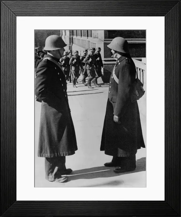 Framed Print : Nazi occupation of Norway during World War 2. Two Norwegian policemen watching a detachment of German troops marching through Oslo, May 11, 1940. (BSLOC_2013_11_53)