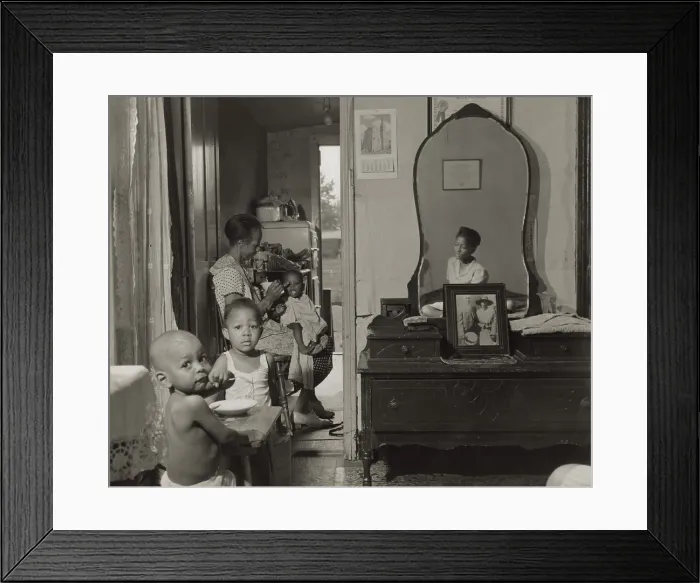 Framed Print : Dinner time at the home of Mrs. Ella Watson, a government charwoman. She feeds the youngest of her three grandchildren in their Washington D.C. apartment