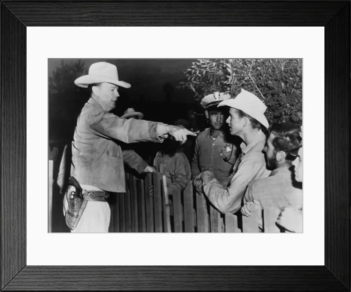 Framed Print : Police chief instructs officers and young men on the other side of a fence, at a polygamist settlement in Short Creek, Arizona