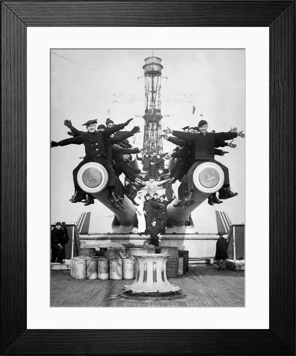 Framed Print : Gobs and Guns. Aboard the U.S.S. Texas, just back from foreign waters, showing sailors enjoying a little fun on the big guns. World War I. Ca. 1918