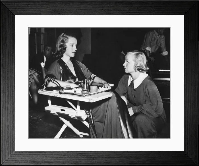 Framed Print : Betty Davis with her stand-in Sally Sage on the set for That Certain Woman'. Sage worked as a stand-in for four years and bears a remarkable resemblance to Davis Framed Print : Betty Davis with her stand-in Sally Sage on the set for That Certain Woman'. Sage worked as a stand-in for four years and bears a remarkable resemblance to Davis