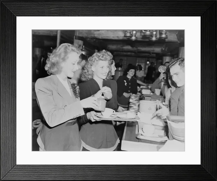 Framed Print : Marlene Dietrich and Rita Hayworth serve soldiers at the Hollywood Canteen during World War 2. Nov. 17, 1942. - (BSLOC_2014_17_76)
