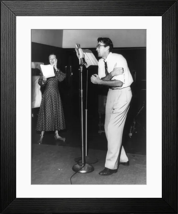 Framed Print : Gregory Peck at microphone with Kay Brinker in a radio play, Hitch-Hike Poker'. Peck plays a hitchhiking war veteran