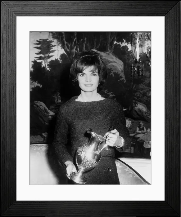 Framed Print : Jacqueline Kennedy holds a silver pitcher presented by James Hogan Alexander, an old family friend for the White House. Dec. 05, 1962