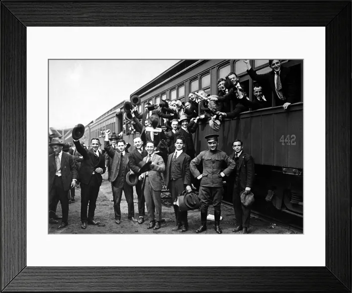Framed Print : New Yorkers board a train on their way to Camp Upton for basic training. The well dressed group in their three piece suits wave to the news photographer's camera. World War I