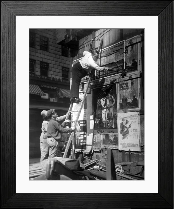 Framed Print : Second Liberty Loan Campaign during World War I. Movie star Fattie Arbuckle, balanced on a ladder, putting up a Liberty Loan poster at Times Square, New York. Oct. 1917