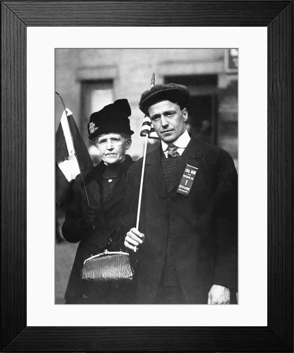 Framed Print : Mother escorting her son to train, who is bound for training camp. He carries a flag and wears a ribbon reading, Local Board for Division No. 1, City of Newark. World War I
