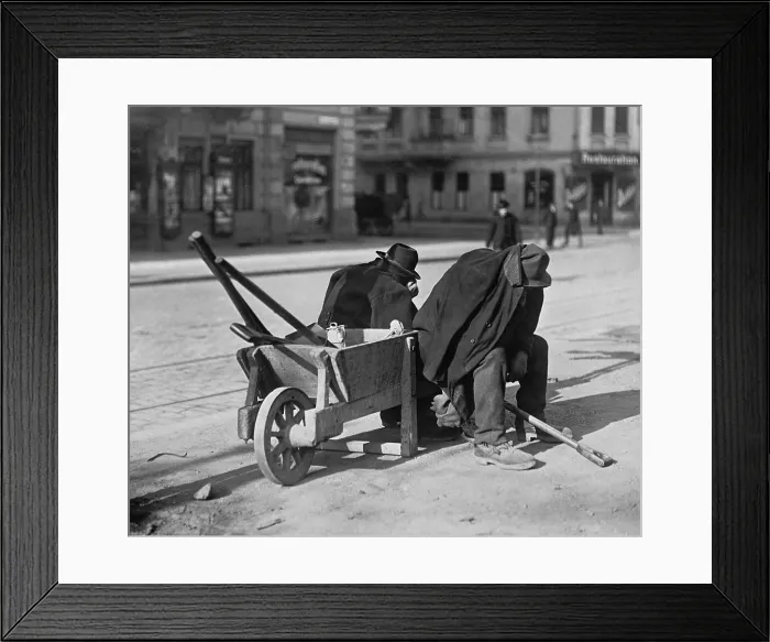 Framed Print : German street sweepers taking lunchtime nap. Wartime and defeat took a terrible economic toll on Germany. Ca. 1919