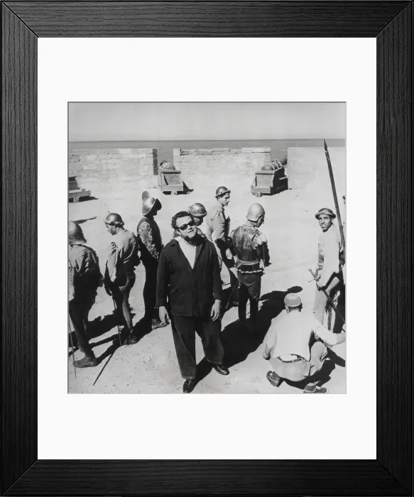 Framed Print : Orson Welles directing the 1952 film, Othello'. He was filming the ramparts and cannons of the Portuguese Fort at Nagador, Morocco