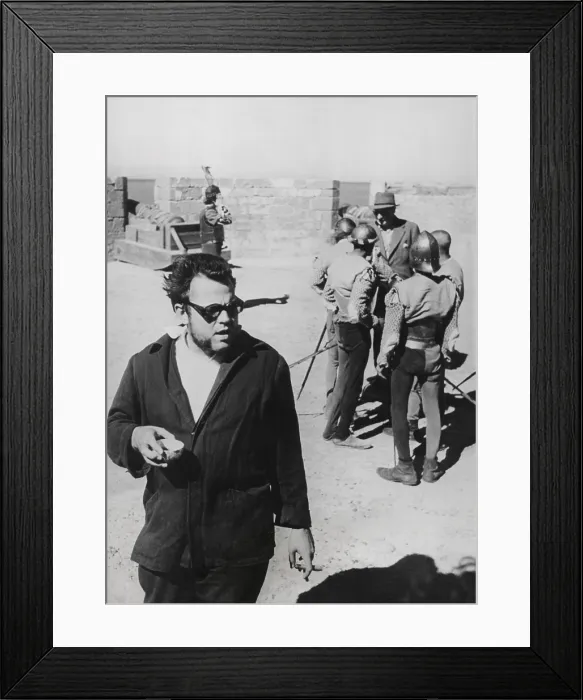 Framed Print : Orson Welles directing the 1952 film, Othello'. He was filming the ramparts and cannons of the Portuguese Fort at Nagador, Morocco. Welles also played the title role