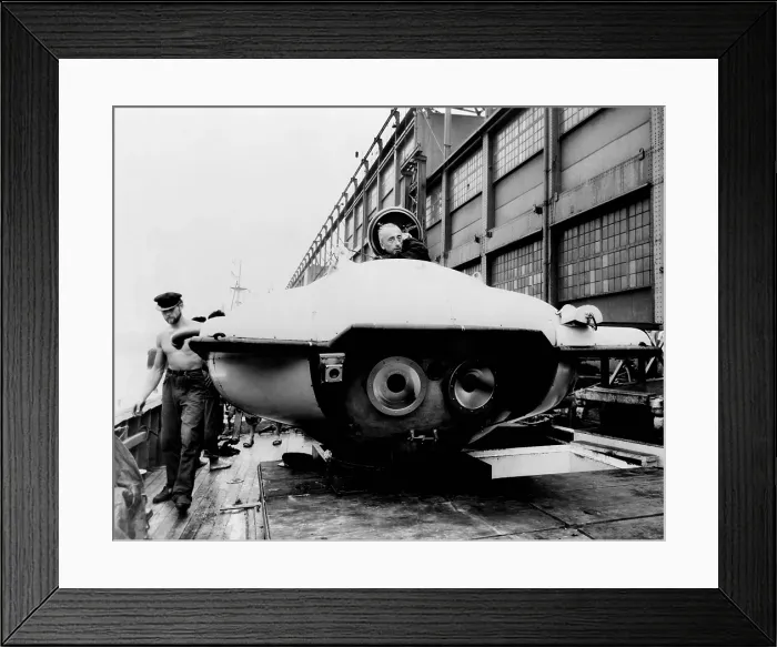 Framed Print : Jacques Cousteau, peering out a two-man underwater observation chamber on board the Calypso as it docks in New York City for the International Oceanographic Congress